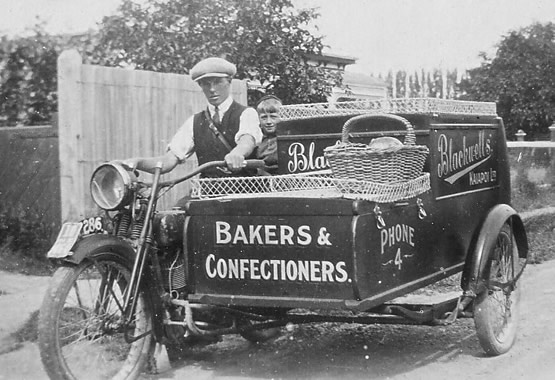 Blackwell delivery motorcycle and sidecar, 1920. Driver is Gordon Fisher, boy behind driver is Des Ashley. Motorcycle and sidecar