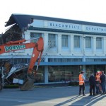 The family conferring with the demolition guys